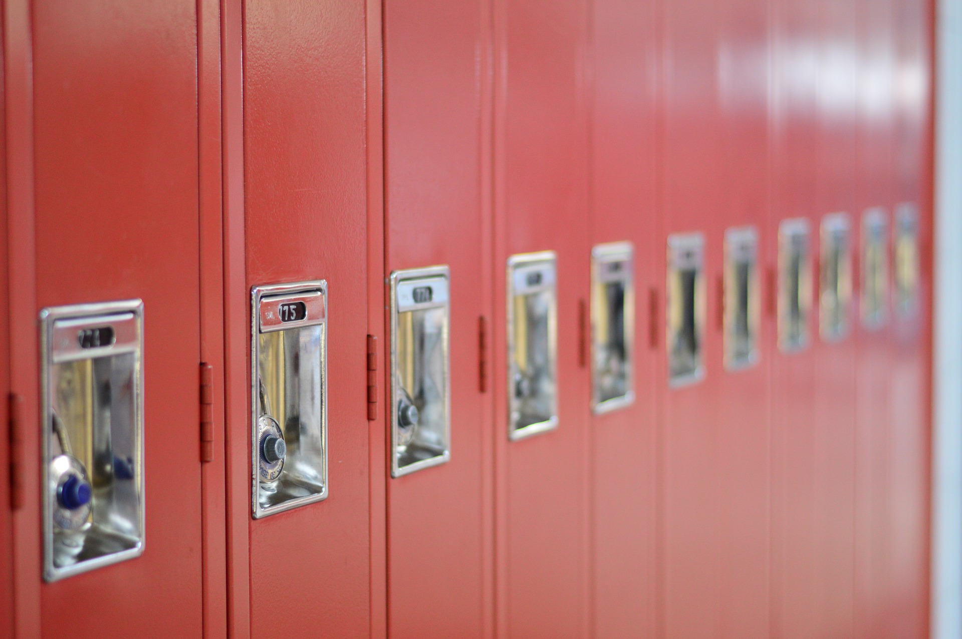 red lockers with padlocks in a school